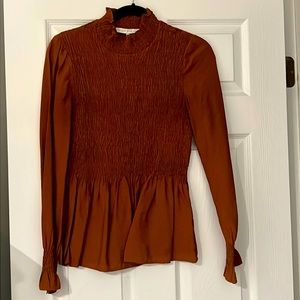 Long sleeve mock neck smocked peplum top